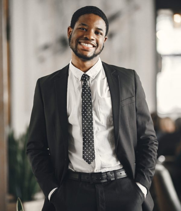 African man in a black suit. Guy with beard.